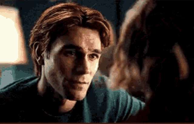 a man and a woman are looking at each other in a room .