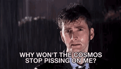 a man in a suit and tie is crying in the rain and asking why won t the cosmos stop pissing on me ?