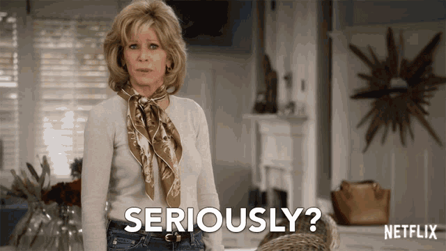 a woman with a scarf around her neck is saying seriously