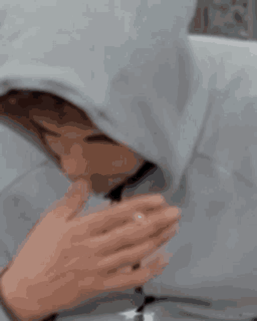 a close up of a person wearing a hoodie with a hood .
