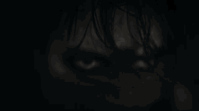 a close up of a person 's face with a black background