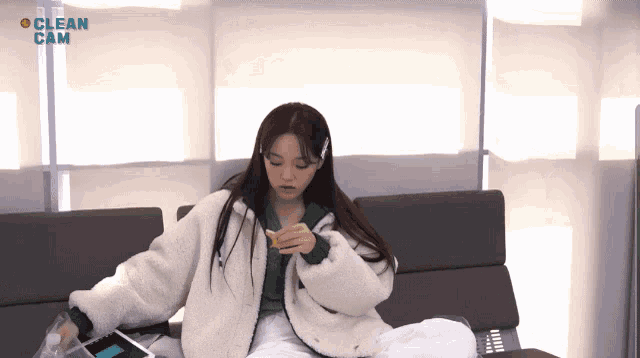 a girl is sitting on a couch with the words clean cam in the background