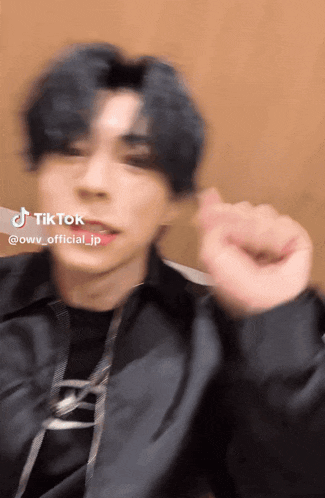 a close up of a person 's face with a tiktok logo on the bottom