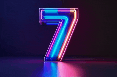 the number seven is glowing in the dark with purple and blue lights .