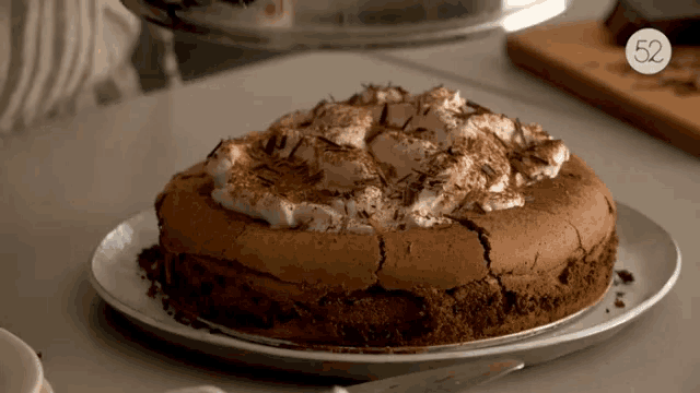 a cake on a plate with the number 52 on the bottom right