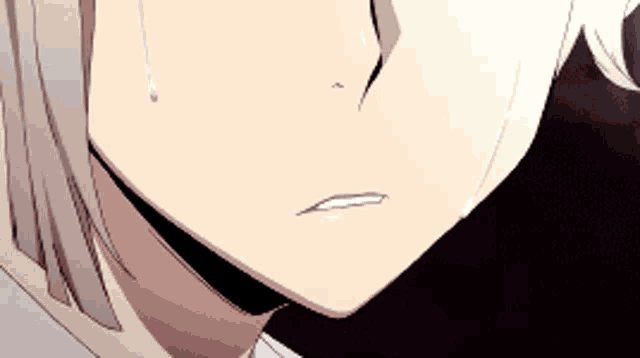 a close up of a person 's face with a tear coming out of their eye