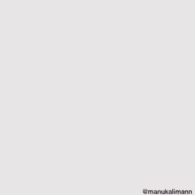 a woman wearing a leather jacket and jeans is dancing against a white wall .