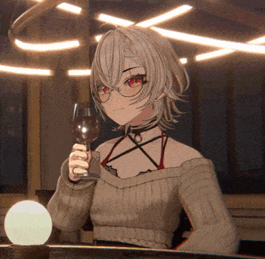 a girl in a sweater holds a glass of wine