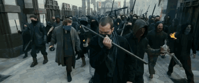 a group of people wearing masks and holding swords and torches