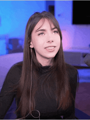 a woman wearing headphones is smiling and looking up