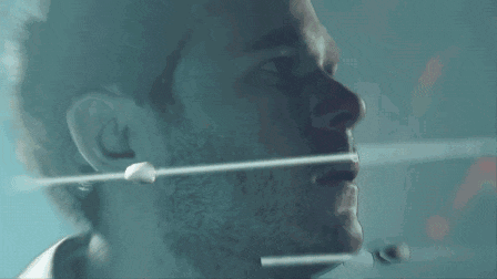 a close up of a man 's face with a string coming out of his nose