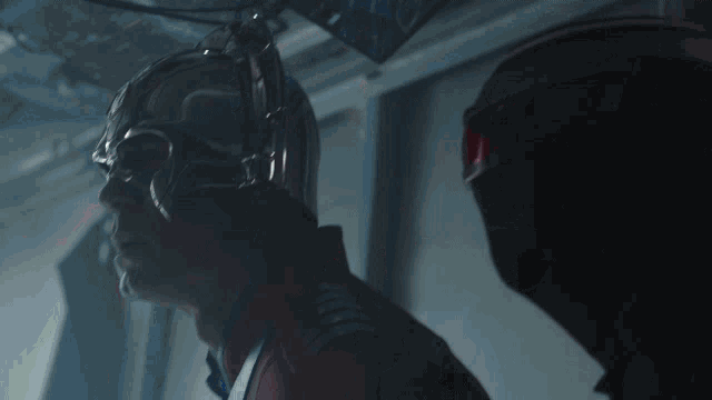 a man wearing a helmet and goggles looks up at something
