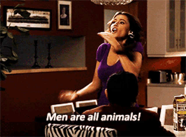 a woman says men are all animals while a man sits on a zebra print couch