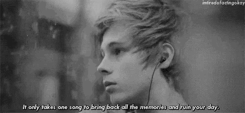 a black and white photo of a young man wearing headphones with a quote .