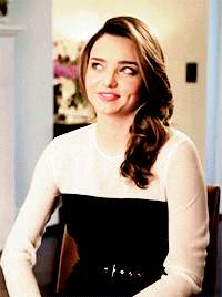 a woman wearing a black and white dress is smiling
