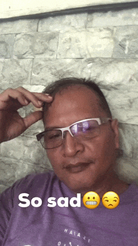 a man wearing glasses and a purple shirt with the words so sad on it