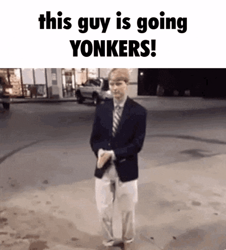 a man in a suit and tie is walking down a street and says this guy is going yonkers !