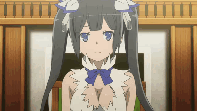 a girl with long black hair and blue eyes is sitting on a chair