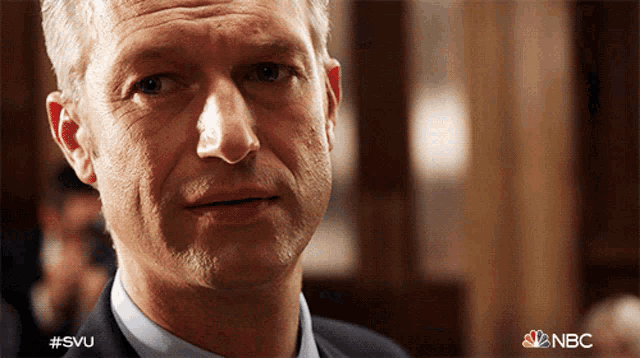 a close up of a man 's face with #svu written on the bottom