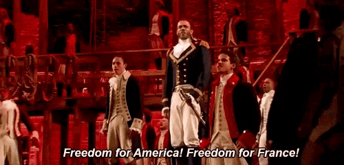 a group of men in military uniforms are standing on a stage and shouting freedom for america ! freedom for france !