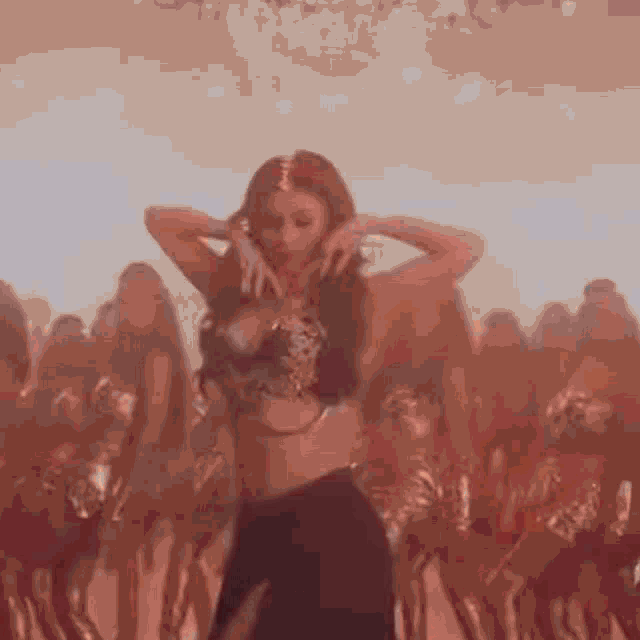 a woman dancing in front of a crowd of people
