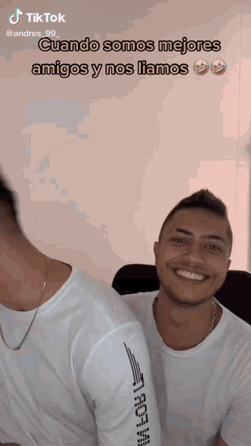 a man in a white shirt with the word roja on the arm smiles