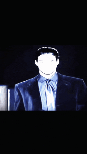 a man in a suit and tie with his face visible