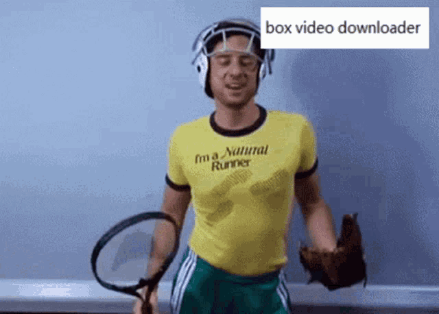 a man in a yellow shirt that says " i 'm a natural runner " is holding a tennis racquet