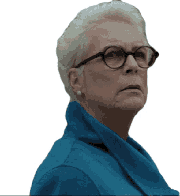 an older woman wearing glasses and a blue jacket looks to the side
