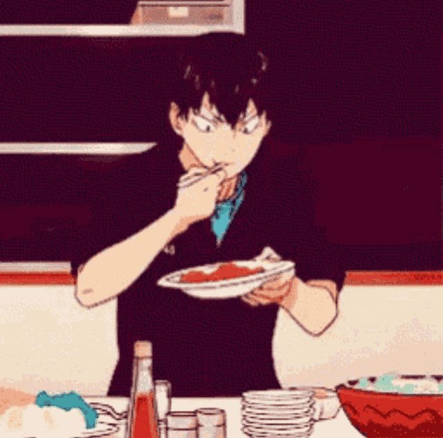 a man is sitting at a table eating a plate of food with a fork .