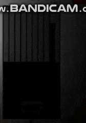 a black box is sitting in a dark room with the words bandicam.com written on the bottom .