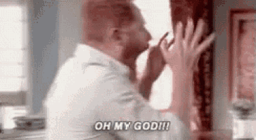 a man is standing in front of a window and saying `` oh my god !!! '' .