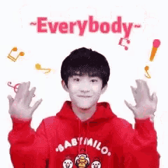 a young boy in a red hoodie is making a funny face .