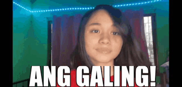 a girl is smiling with the words ang galing behind her