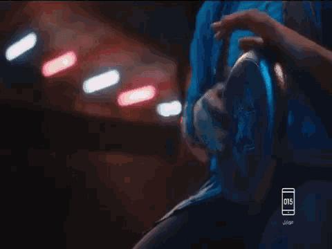 a person is holding a steering wheel in a dark room with a jeep logo in the corner