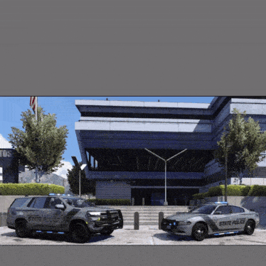 two state police vehicles parked in front of a building