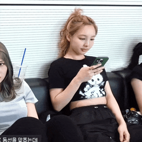 a woman sitting on a couch using her phone