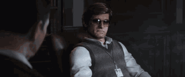a man wearing sunglasses and a name tag that says ' n.o. ' on it
