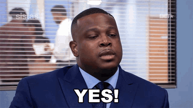 a man in a suit and tie says " yes "
