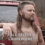 a shirtless man with a mullet and a beard is standing in front of a truck .