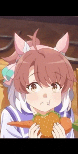 a girl with pink ears is eating a hamburger and carrots