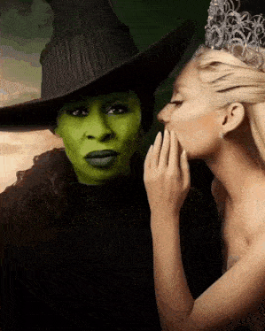 a woman whispering into another woman 's ear while wearing a crown