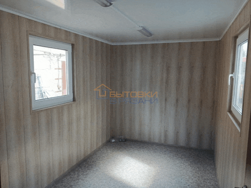 a room with wood paneling and a sign that says " бытовки врабани " on it