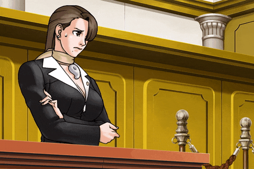 a woman stands at a podium in a courtroom with her hand on her shoulder
