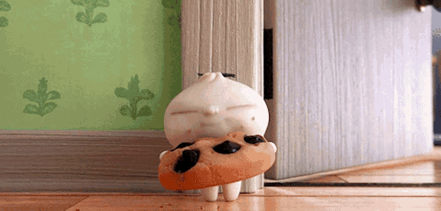 a cartoon character is holding a donut with raisins in it