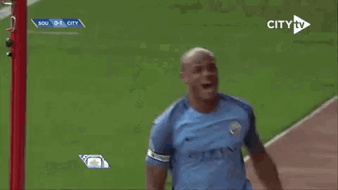 a soccer player named vincent kompany is shown on a city tv screen