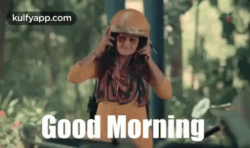 a woman wearing a helmet and sunglasses is talking on a cell phone .