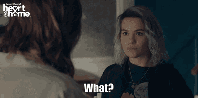 a woman talking to another woman with the words what on the bottom right