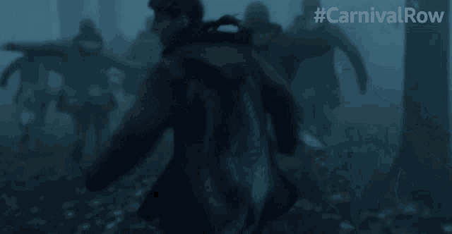 a group of people are running through a foggy forest with #carnivalrow written above them