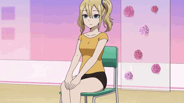 a girl is sitting in a chair with her hands on her chest